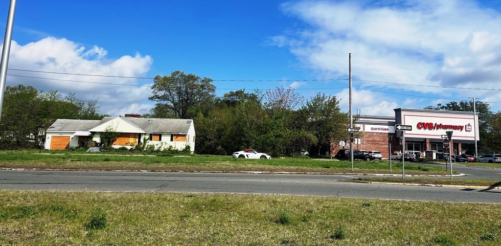 a sign board with buildings in the background