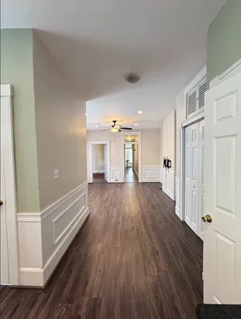 a view of a hallway with wooden floor