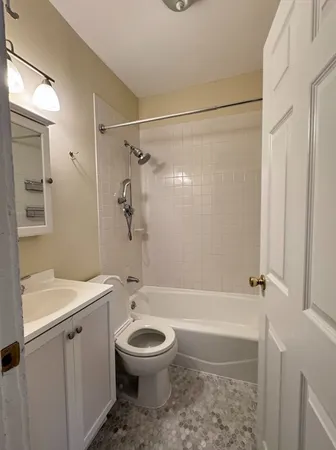 a bathroom with a toilet sink and shower