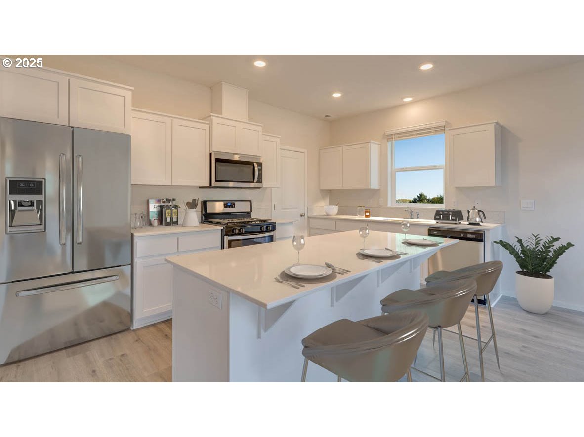 2960 T Street Springfield, OR 97477 - Photo 6 of 9 a kitchen with kitchen island a sink table and chairs