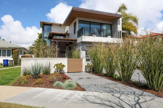 a large kitchen with stainless steel appliances kitchen island granite countertop a lot of cabinets and couches with wooden floor