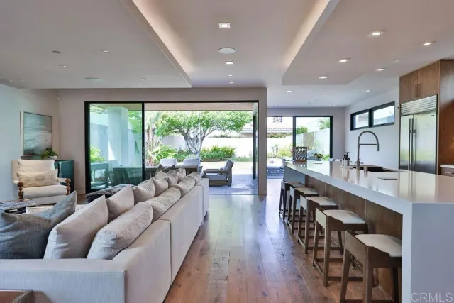a kitchen with stainless steel appliances granite countertop a sink and a wooden cabinets