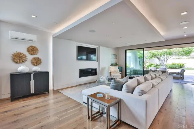 a living room with fireplace furniture and a large window
