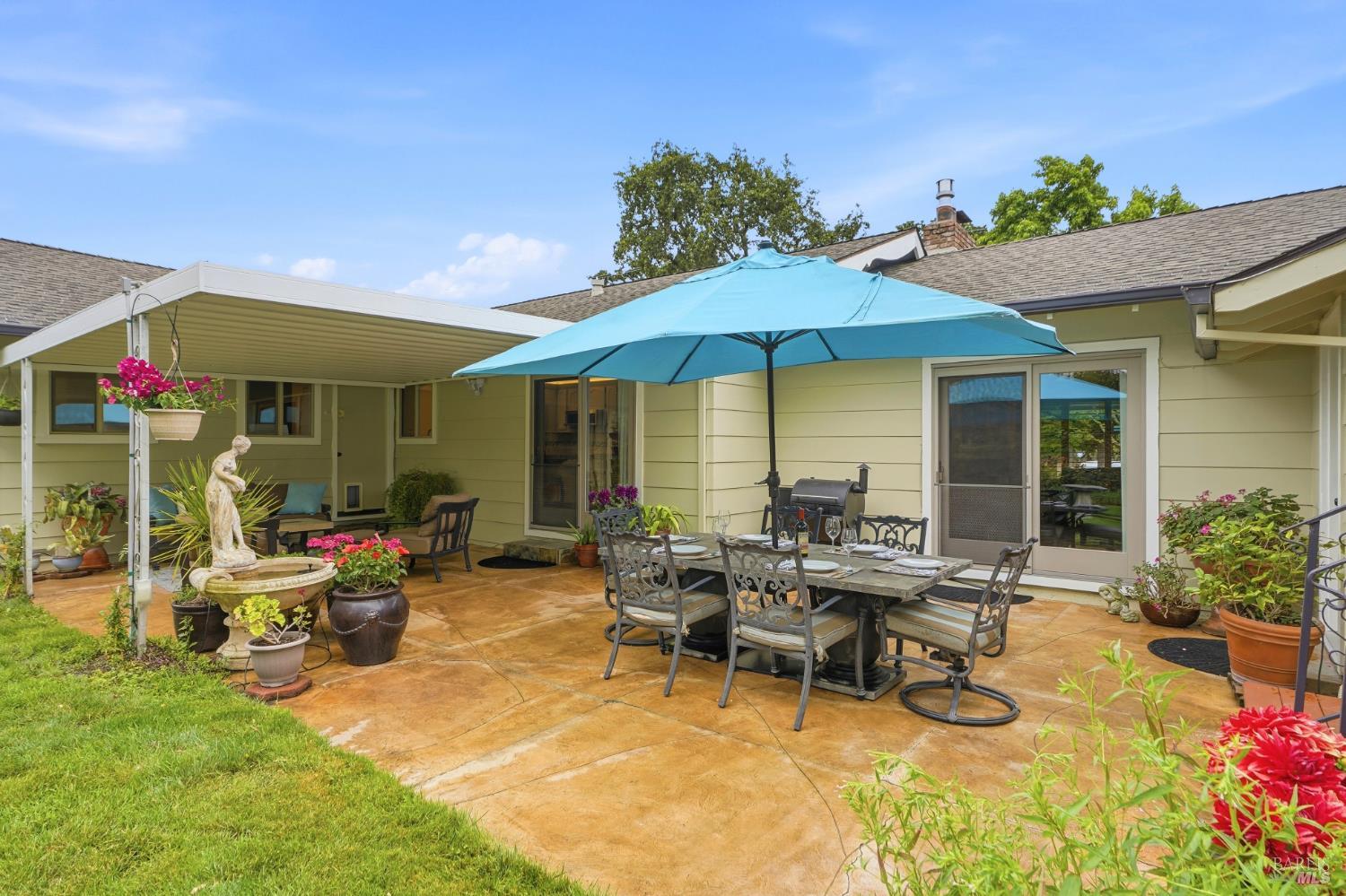 373 Piezzi Road Santa Rosa, CA 95401 - Photo 33 of 55 a view of a patio with table and chairs under an umbrella