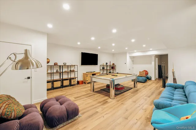 a room with gym equipment and wooden floor