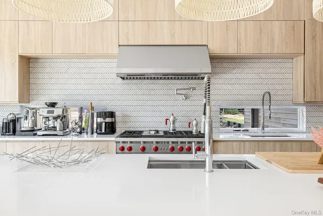 a kitchen with stainless steel appliances kitchen island granite countertop a sink and a stove