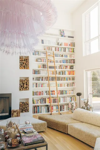 a living room with furniture and a floor to ceiling window