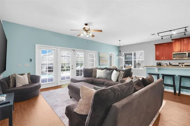 a living room with furniture fireplace and a large window