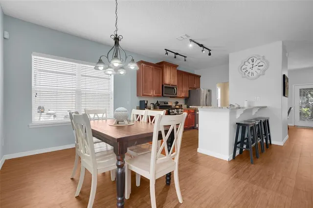 a dining room with furniture and wooden floor