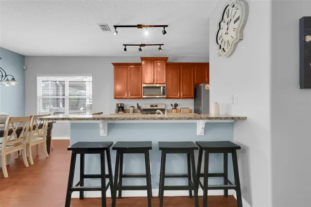 a kitchen with a table chairs cabinets and window