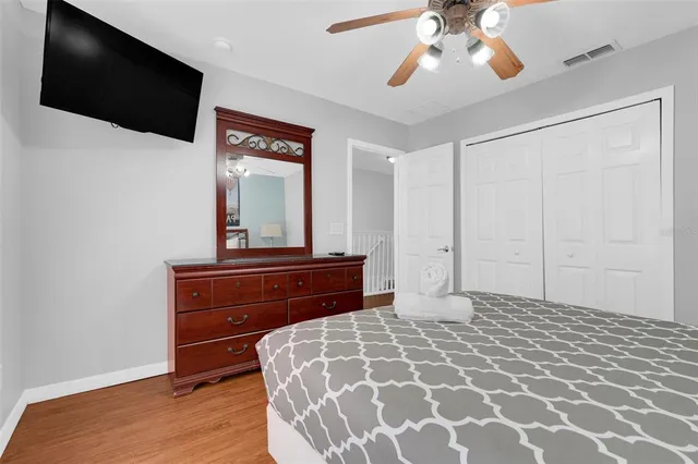 a bedroom with a large bed and a chandelier