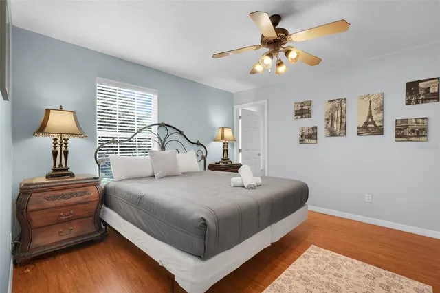 a bathroom with a granite countertop toilet a sink and a window