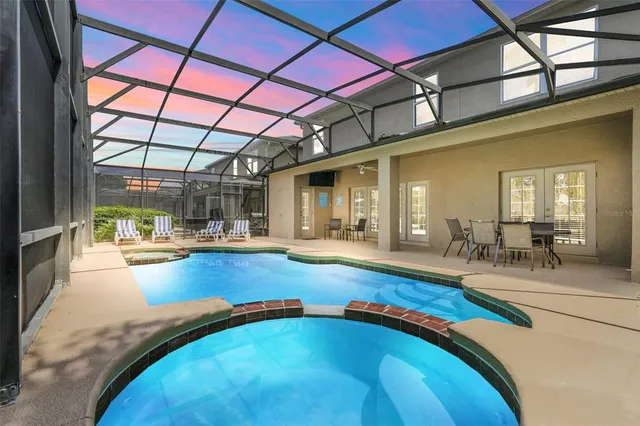 a view of a swimming pool with outdoor seating