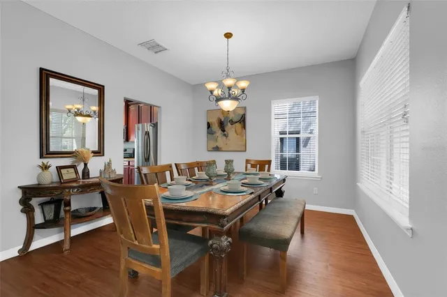 a view of a dining room with furniture window and wooden floor