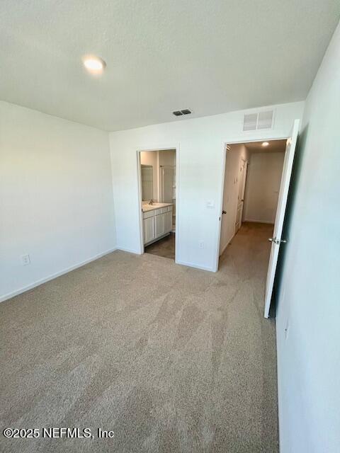 73 Hidden Mdws Road St. Augustine, FL 32095 - Photo 14 of 25 an empty room with closet and mirror