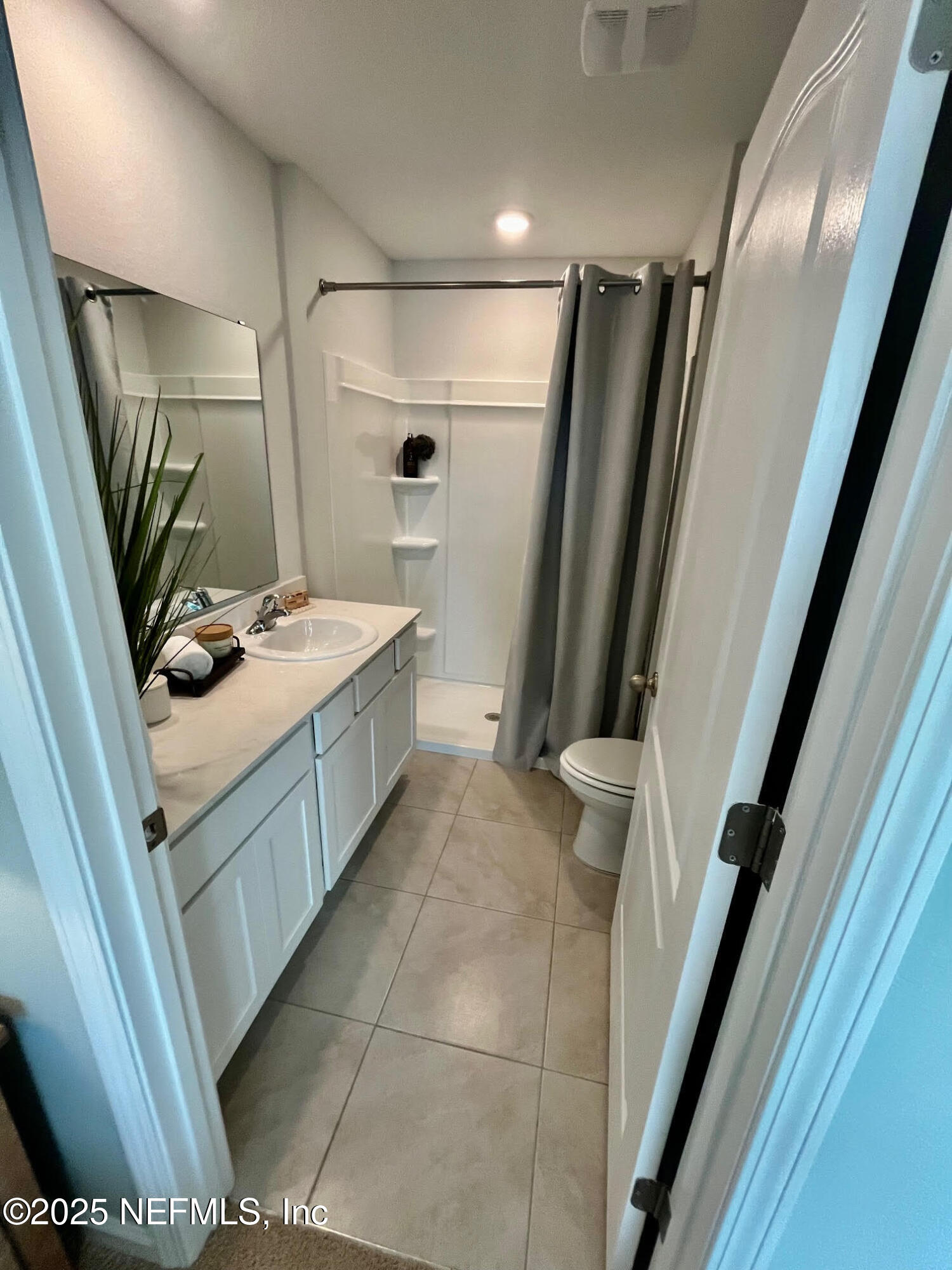 73 Hidden Mdws Road St. Augustine, FL 32095 - Photo 17 of 25 a bathroom with a sink a toilet a mirror and shower