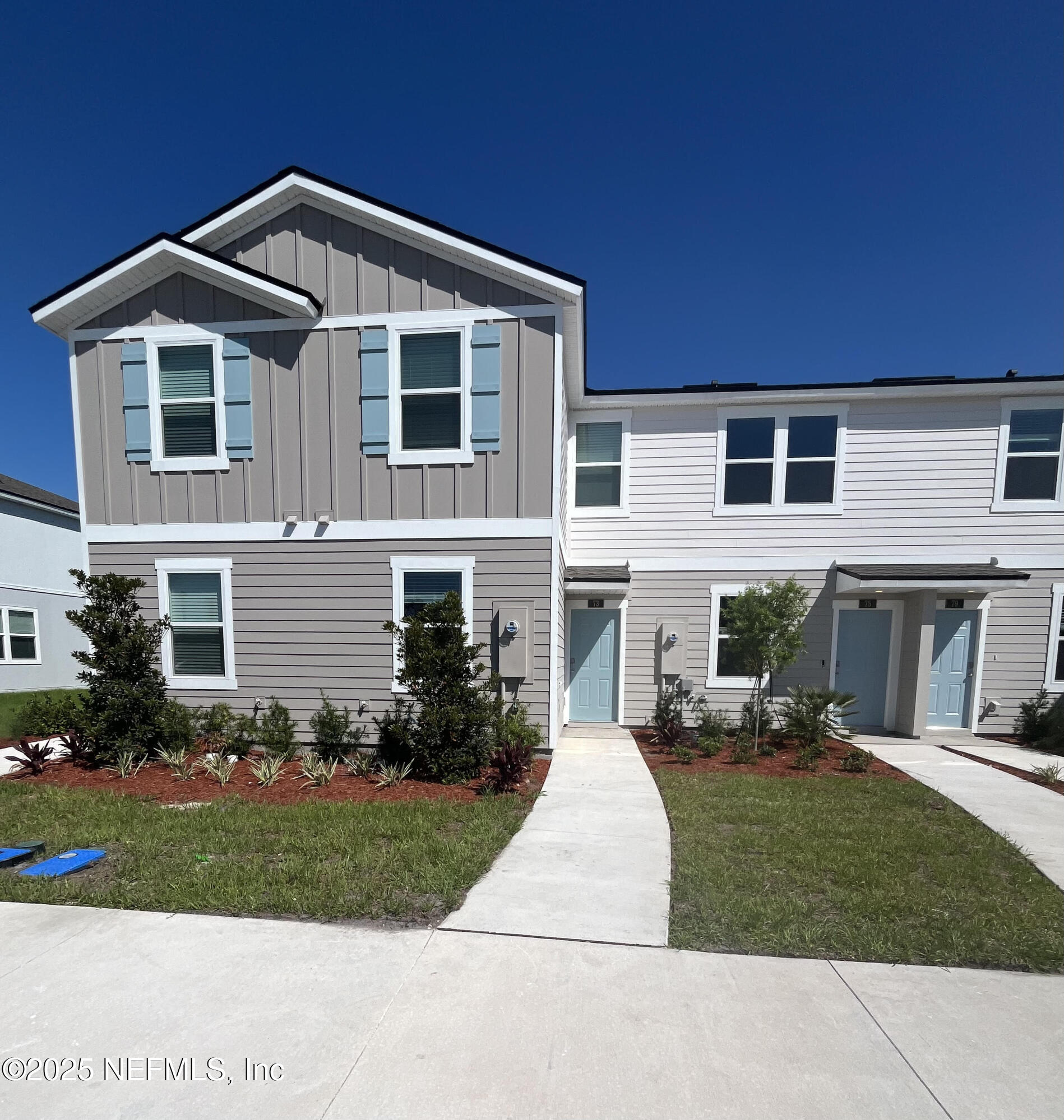 73 Hidden Mdws Road St. Augustine, FL 32095 - Photo 25 of 25 a front view of a house with a yard and potted plants
