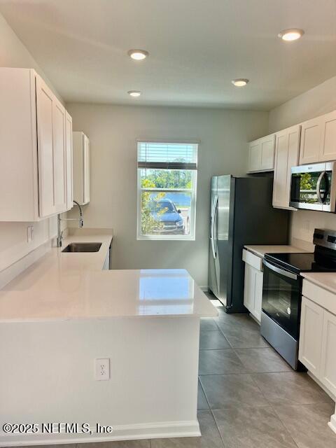 73 Hidden Mdws Road St. Augustine, FL 32095 - Photo 3 of 25 a kitchen with stainless steel appliances granite countertop a refrigerator a stove and a sink with wooden floors