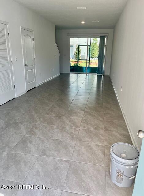 73 Hidden Mdws Road St. Augustine, FL 32095 - Photo 6 of 25 a view of a hallway with wooden floor and a fireplace