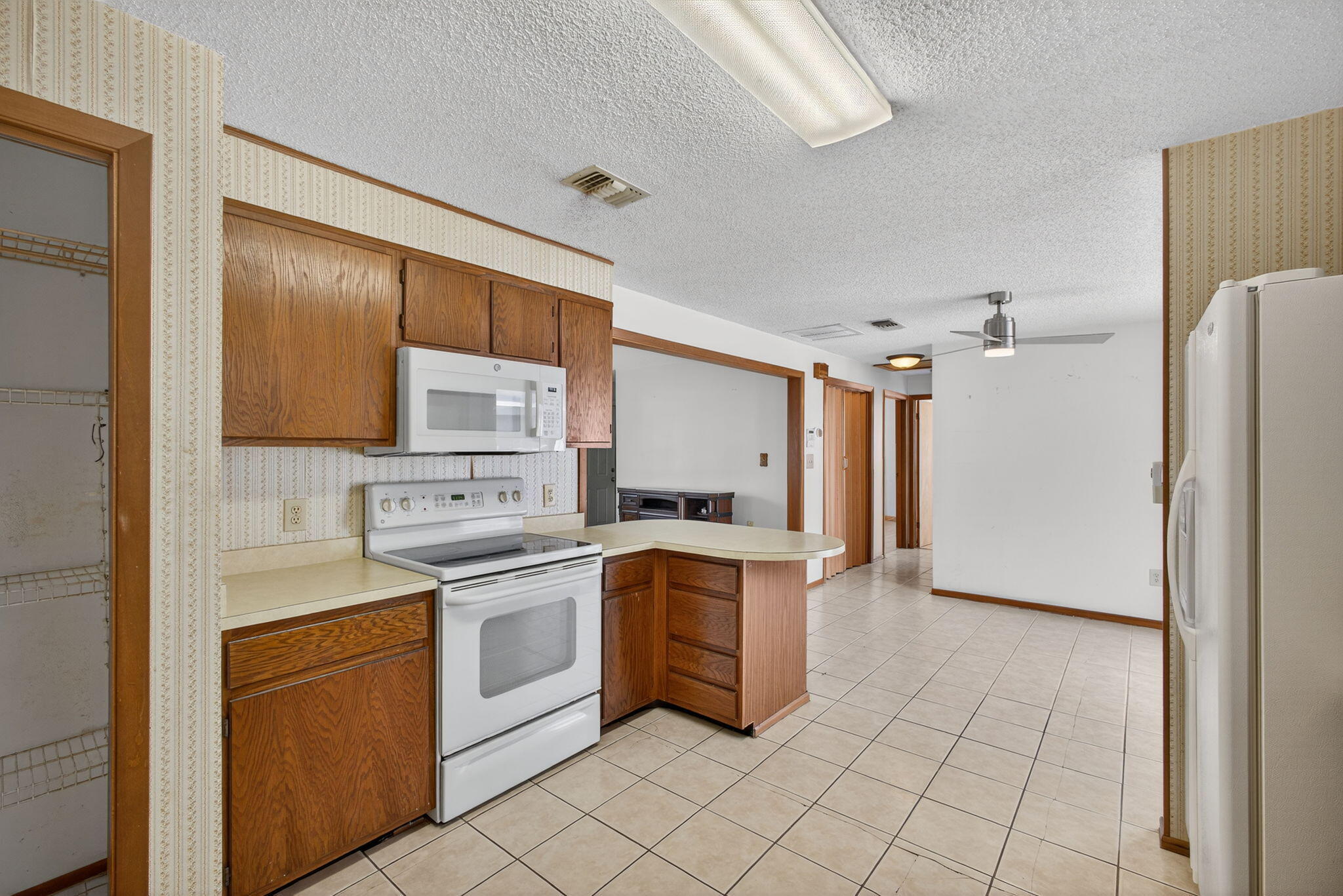 1332 West 33rd Street Riviera Beach, FL 33404 - Photo 12 of 25 a kitchen with a stove sink and cabinets