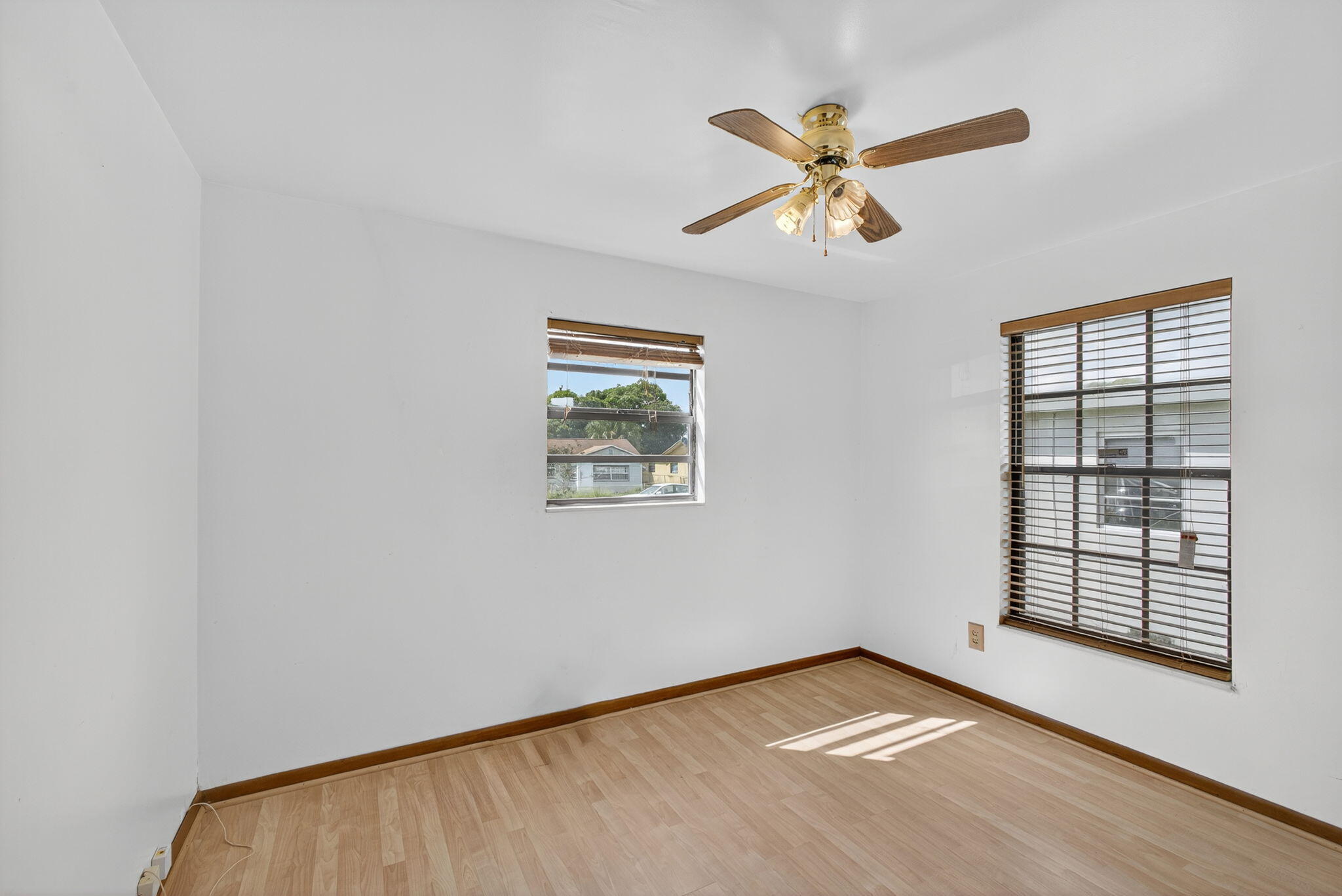 1332 West 33rd Street Riviera Beach, FL 33404 - Photo 20 of 25 an empty room with windows and fan