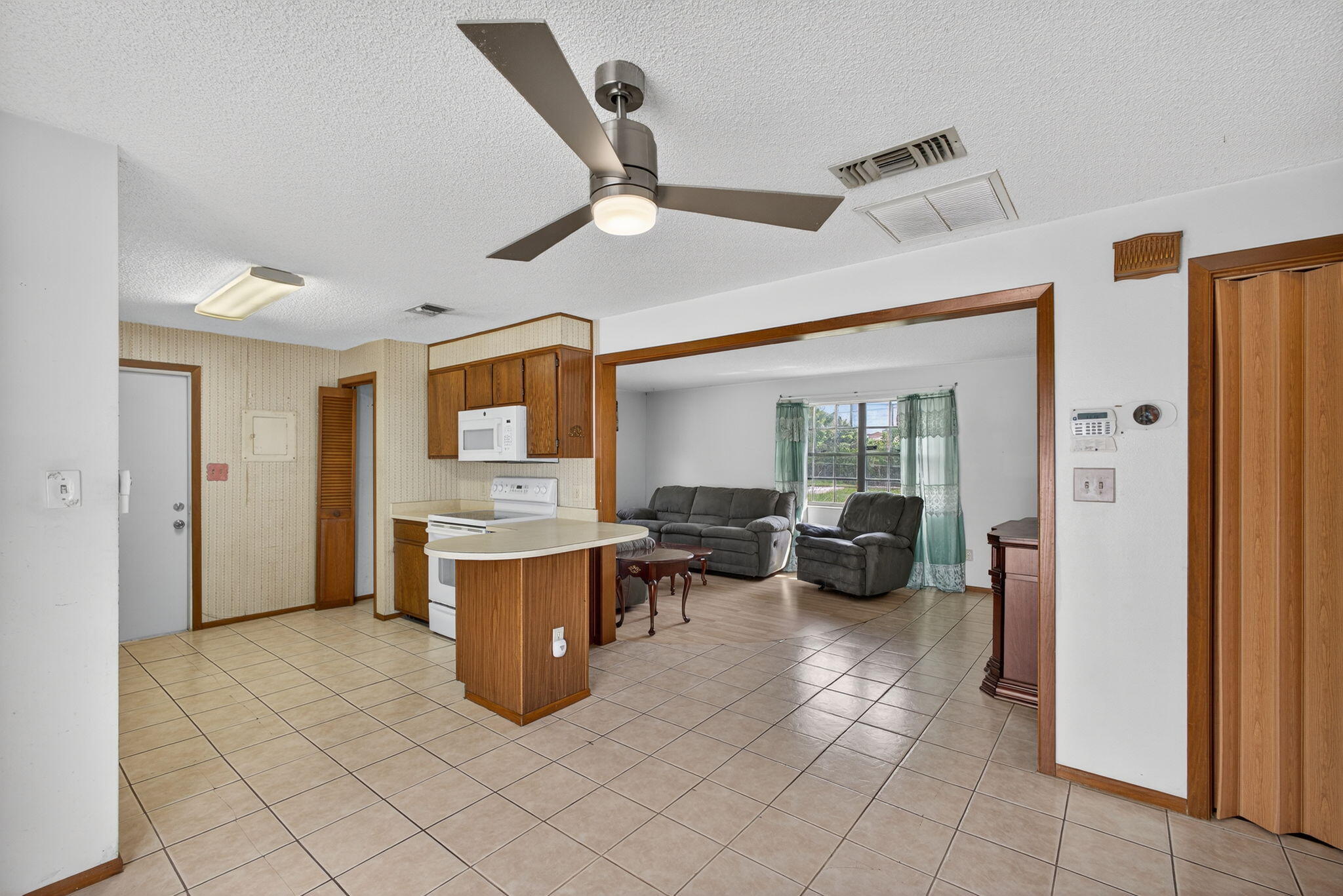 1332 West 33rd Street Riviera Beach, FL 33404 - Photo 7 of 25 a view of a livingroom with furniture and a ceiling fan