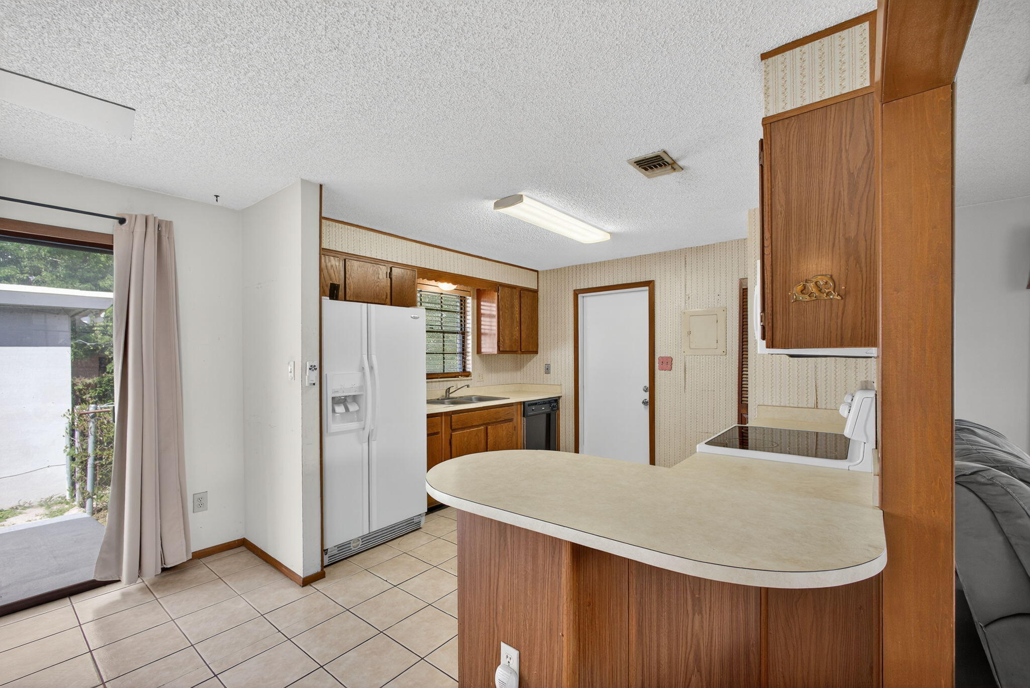1332 West 33rd Street Riviera Beach, FL 33404 - Photo 10 of 25 a kitchen with stainless steel appliances granite countertop a refrigerator and a sink