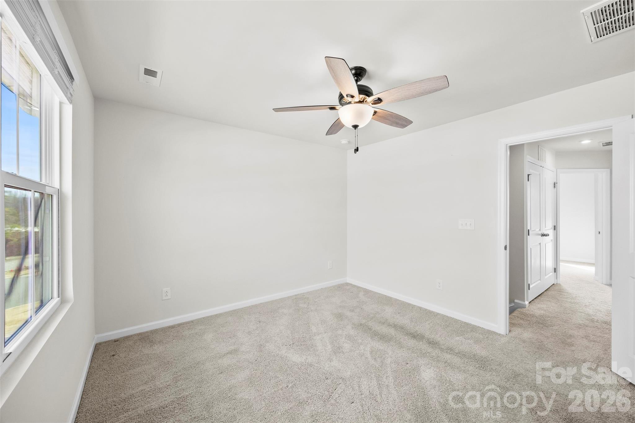 708 Dillon Way Fort Mill, SC 29715 - Photo 16 of 26 an empty room with a window and a fan