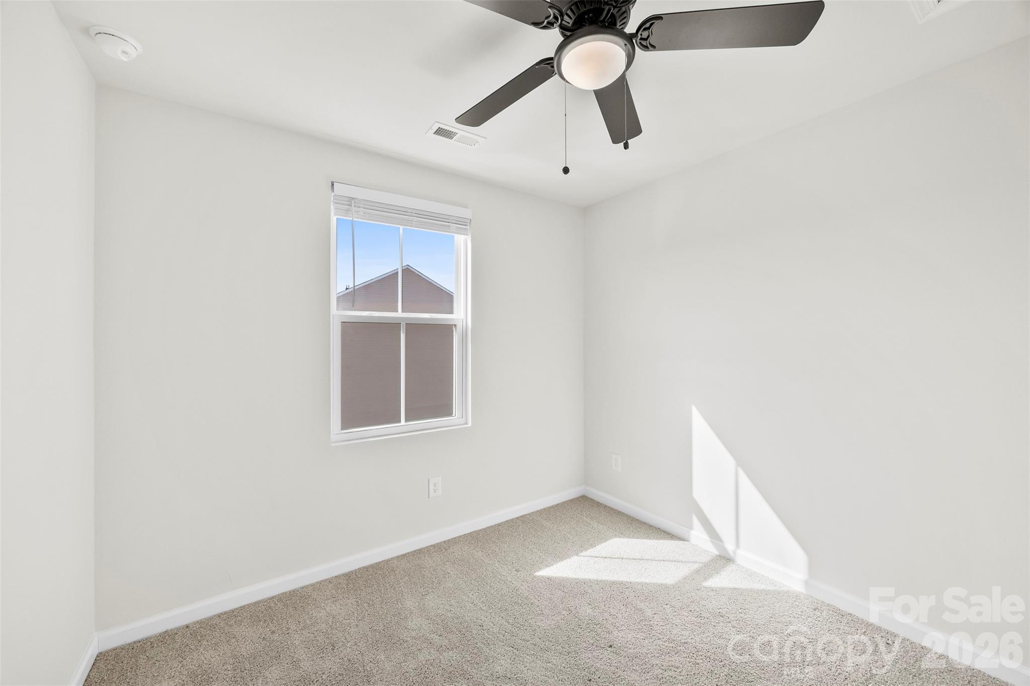 708 Dillon Way Fort Mill, SC 29715 - Photo 21 of 26 an empty room with a window and a fan