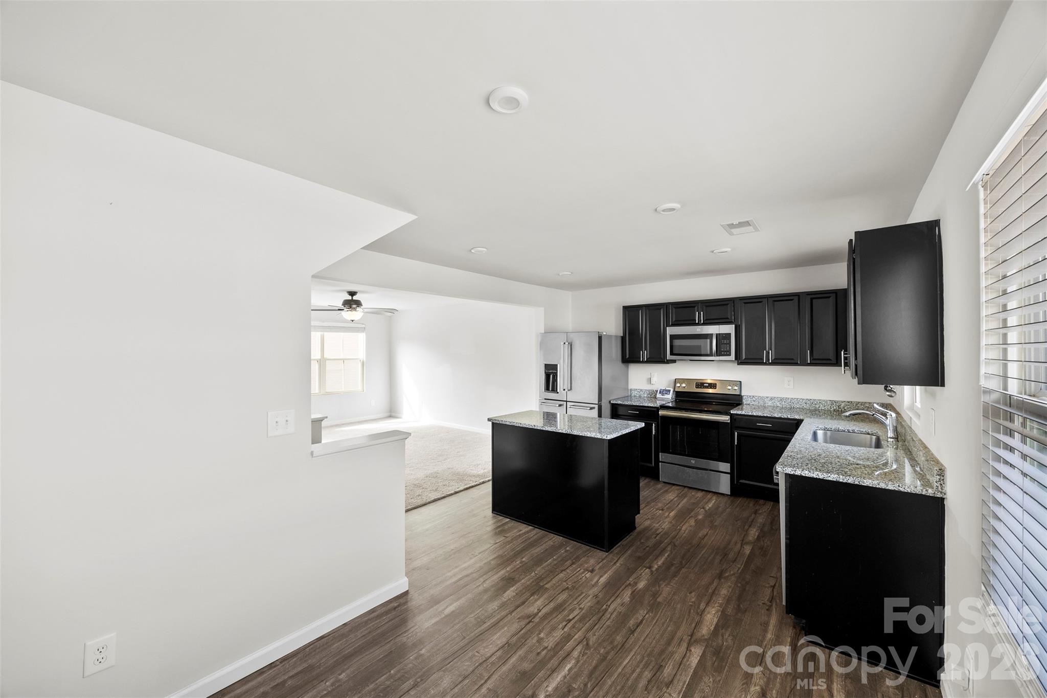 708 Dillon Way Fort Mill, SC 29715 - Photo 7 of 26 a view of kitchen with microwave stove refrigerator and cabinets
