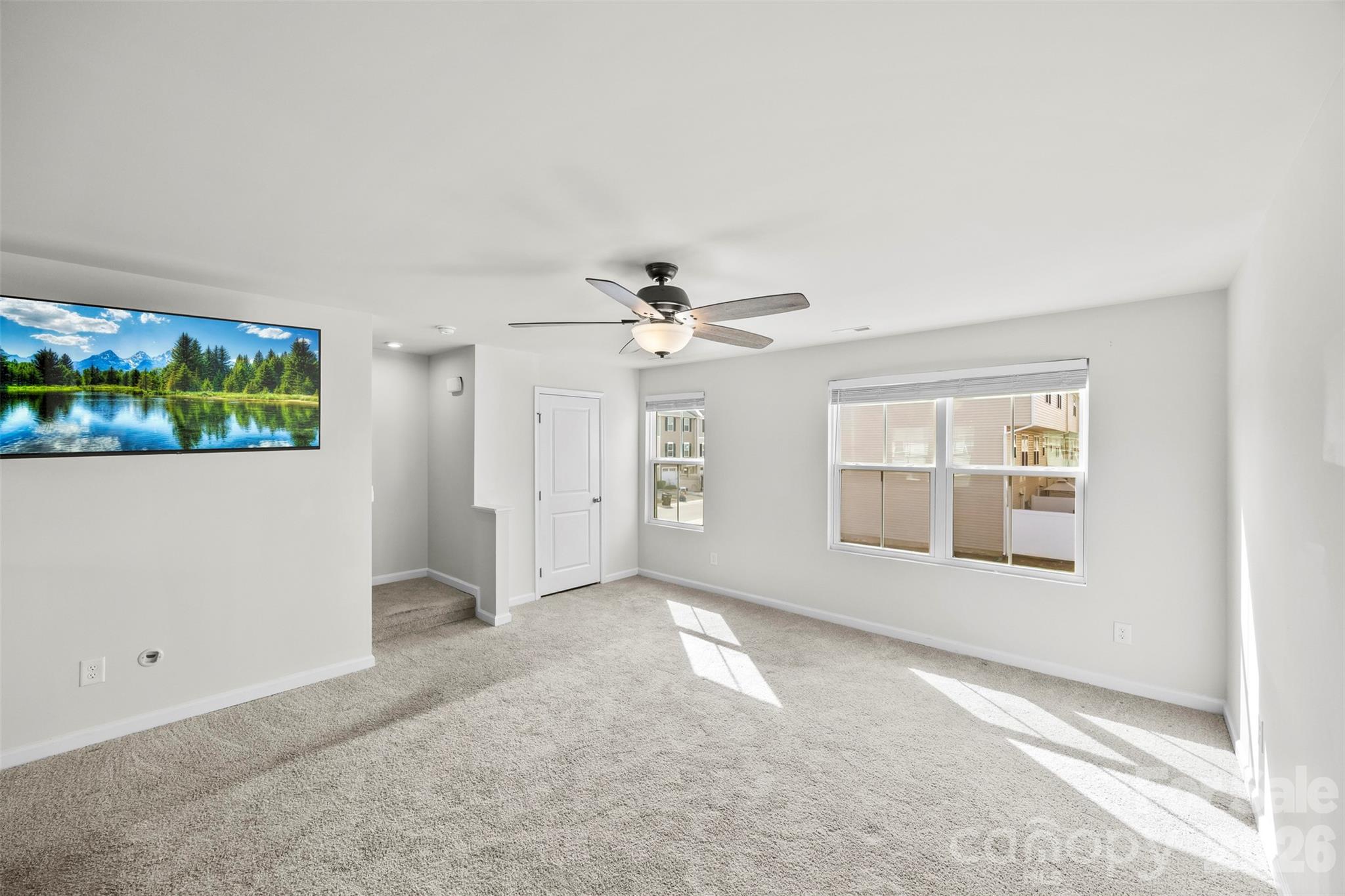 708 Dillon Way Fort Mill, SC 29715 - Photo 9 of 26 an empty room with windows and ceiling fan