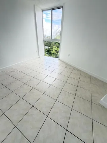 a view of an empty room and a window