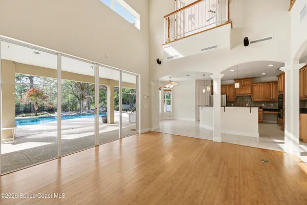 a kitchen with granite countertop a refrigerator and cabinets