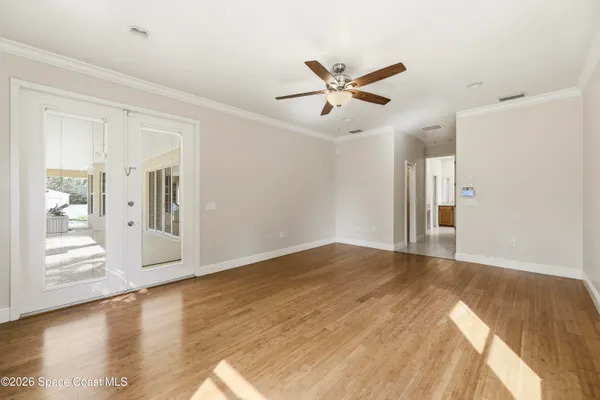an empty room with a window and a ceiling fan