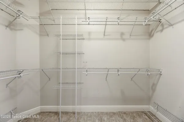 a view of a room with wooden floor and white walls