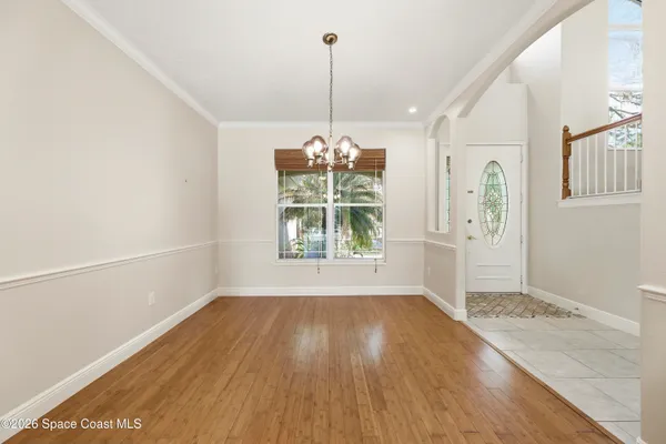 a view of an entryway with wooden floor and windows