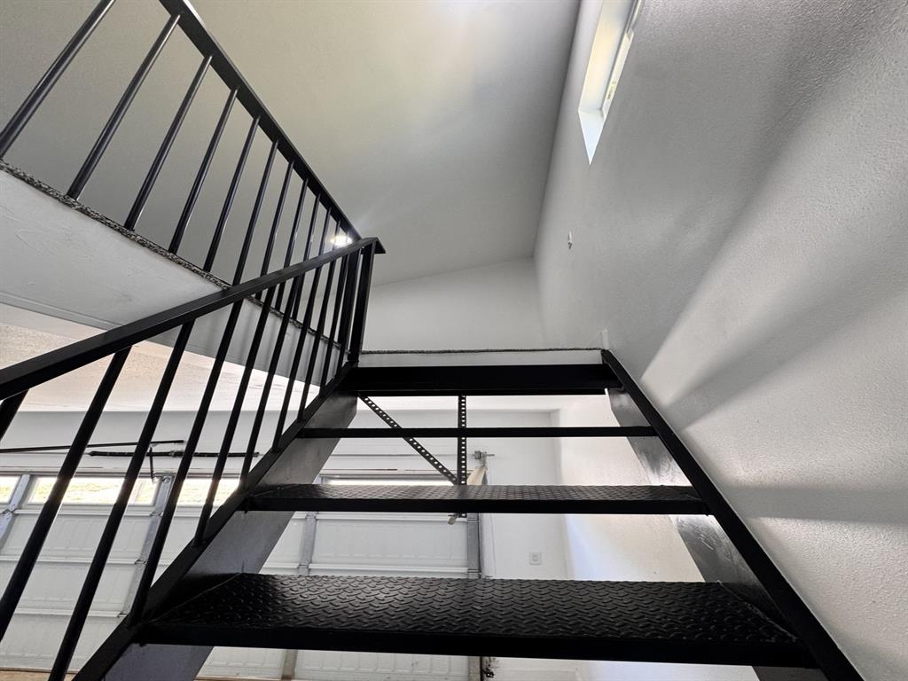 102 Shadywood Road Trinidad, TX 75163 - Photo 24 of 24 Metal staircase with a diamond plate tread and a black metal railing leading to the game room area