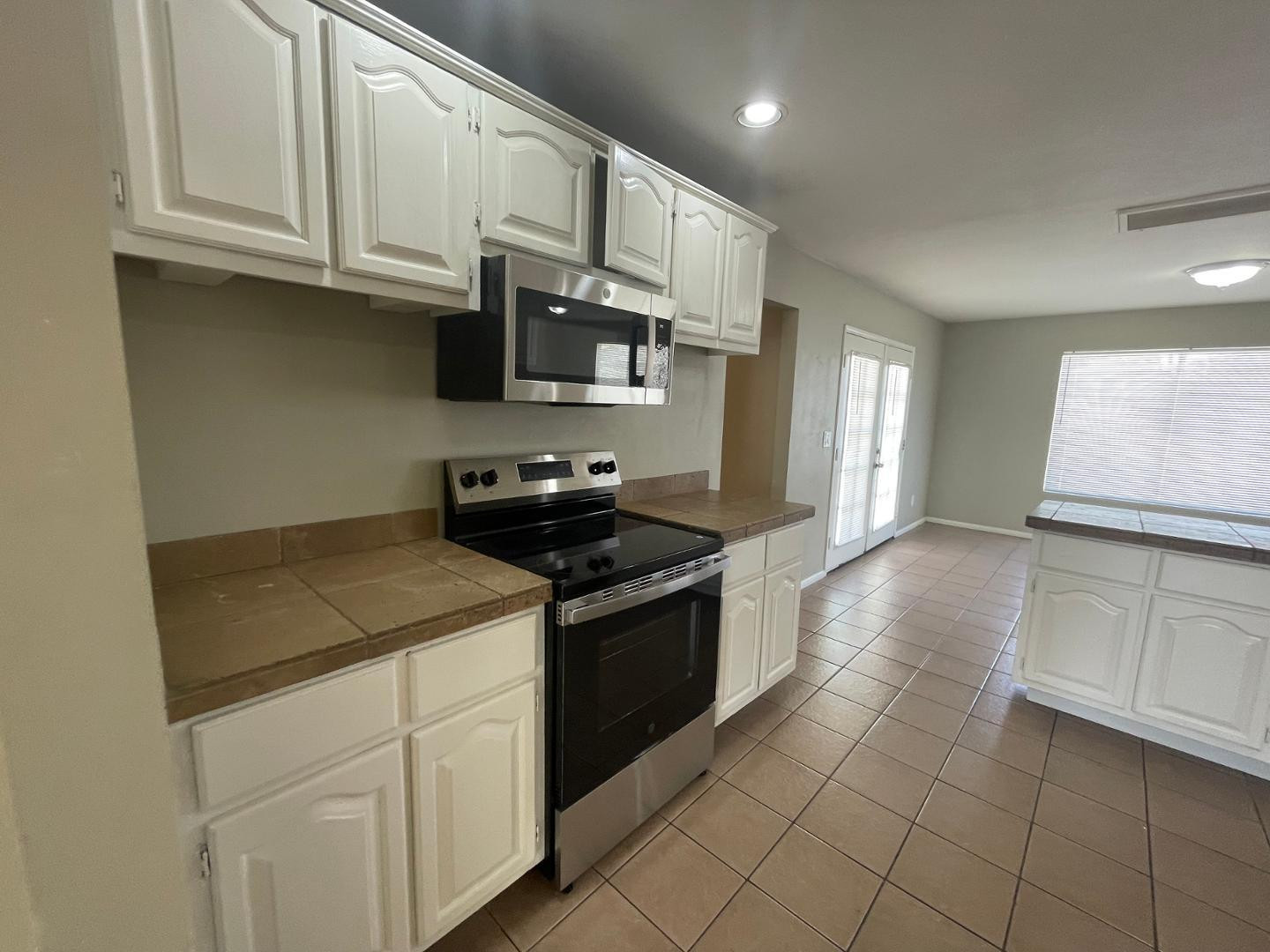 10902 West Montecito Avenue Phoenix, AZ 85037 - Photo 8 of 22 a kitchen with stainless steel appliances granite countertop a sink and a stove
