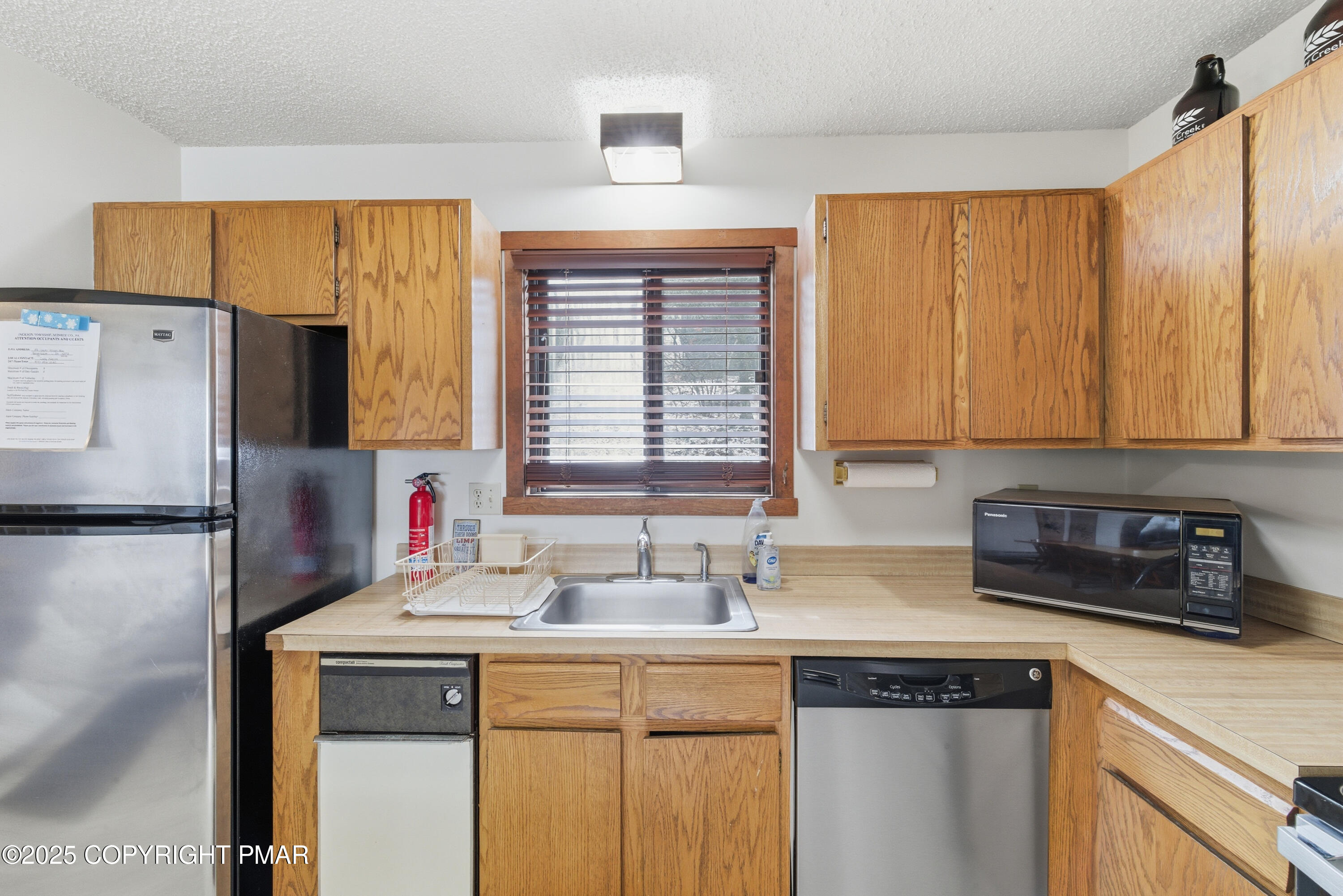 182 Upper Village Way Tannersville, PA 18372 - Photo 11 of 67 a kitchen with stainless steel appliances a sink cabinets and a refrigerator