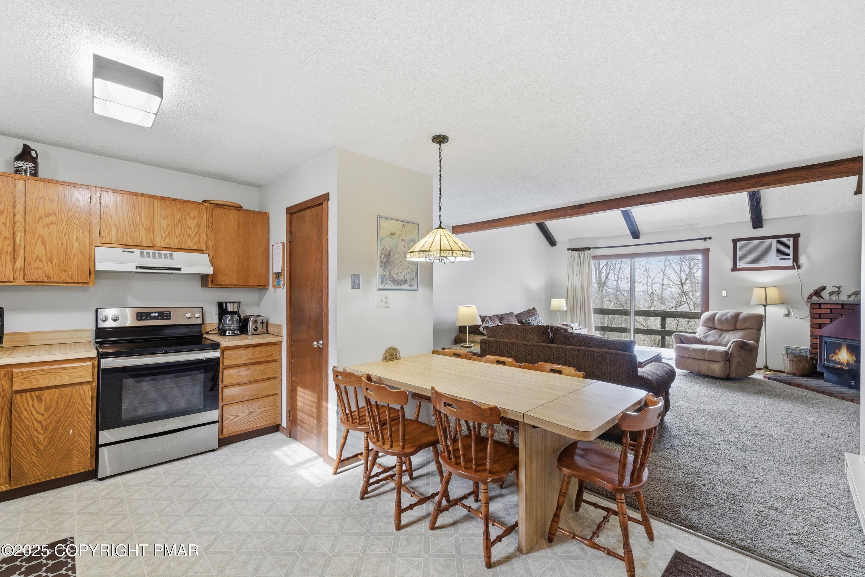 182 Upper Village Way Tannersville, PA 18372 - Photo 13 of 67 a kitchen with a table chairs stove and refrigerator