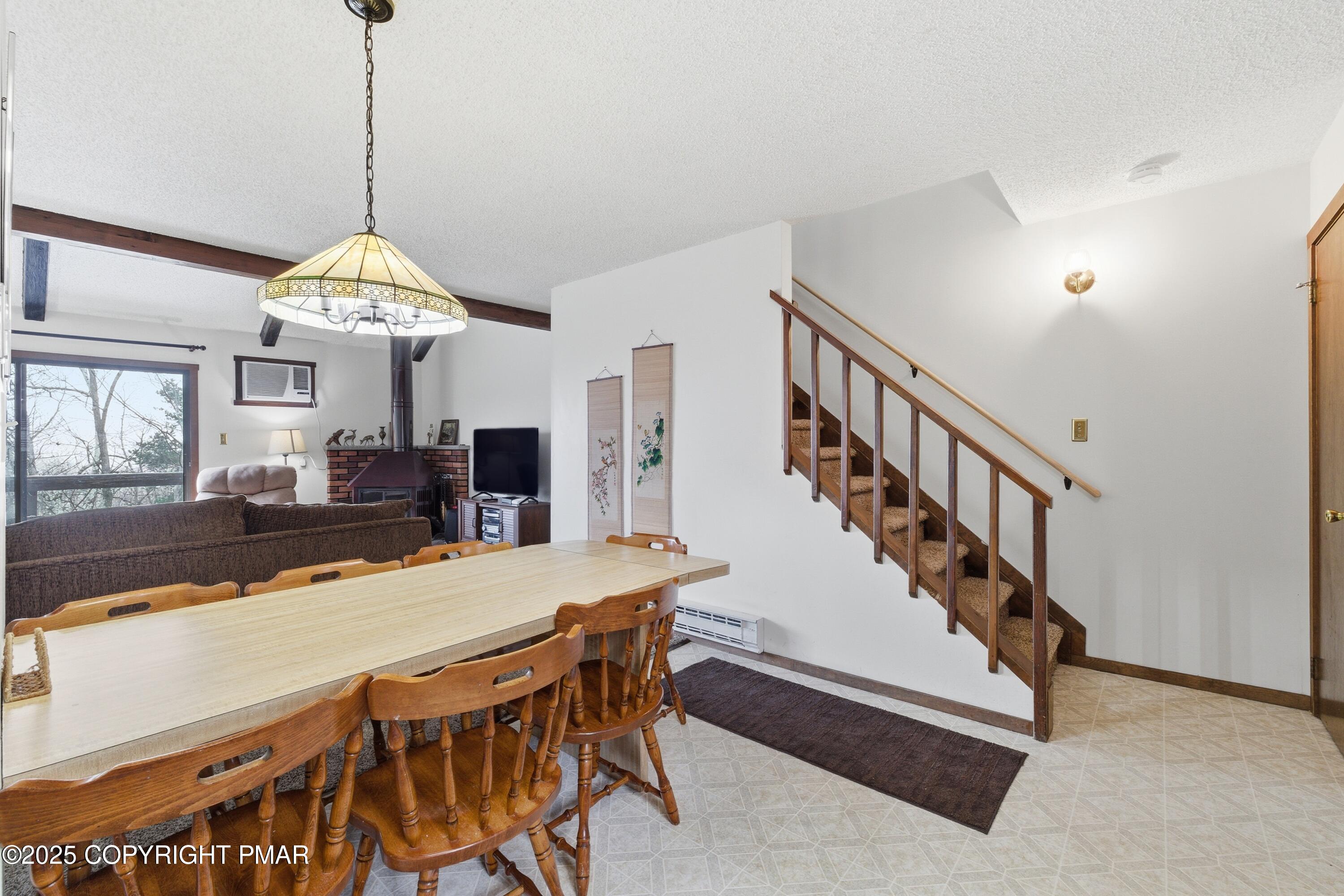 182 Upper Village Way Tannersville, PA 18372 - Photo 15 of 67 a dining room with wooden floor a chandelier a wooden table and chairs