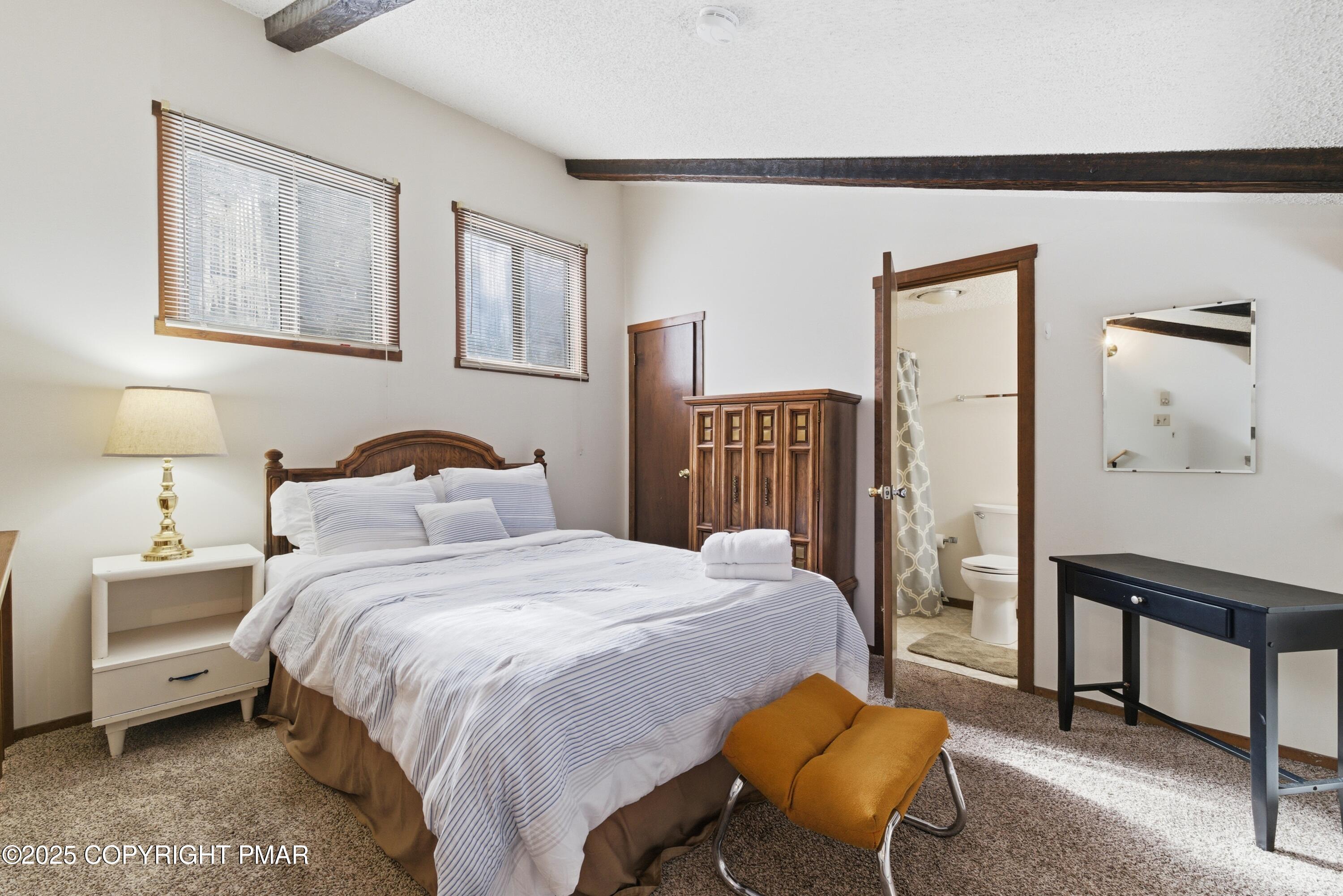 182 Upper Village Way Tannersville, PA 18372 - Photo 17 of 67 a bedroom with a bed a table and painting on the wall