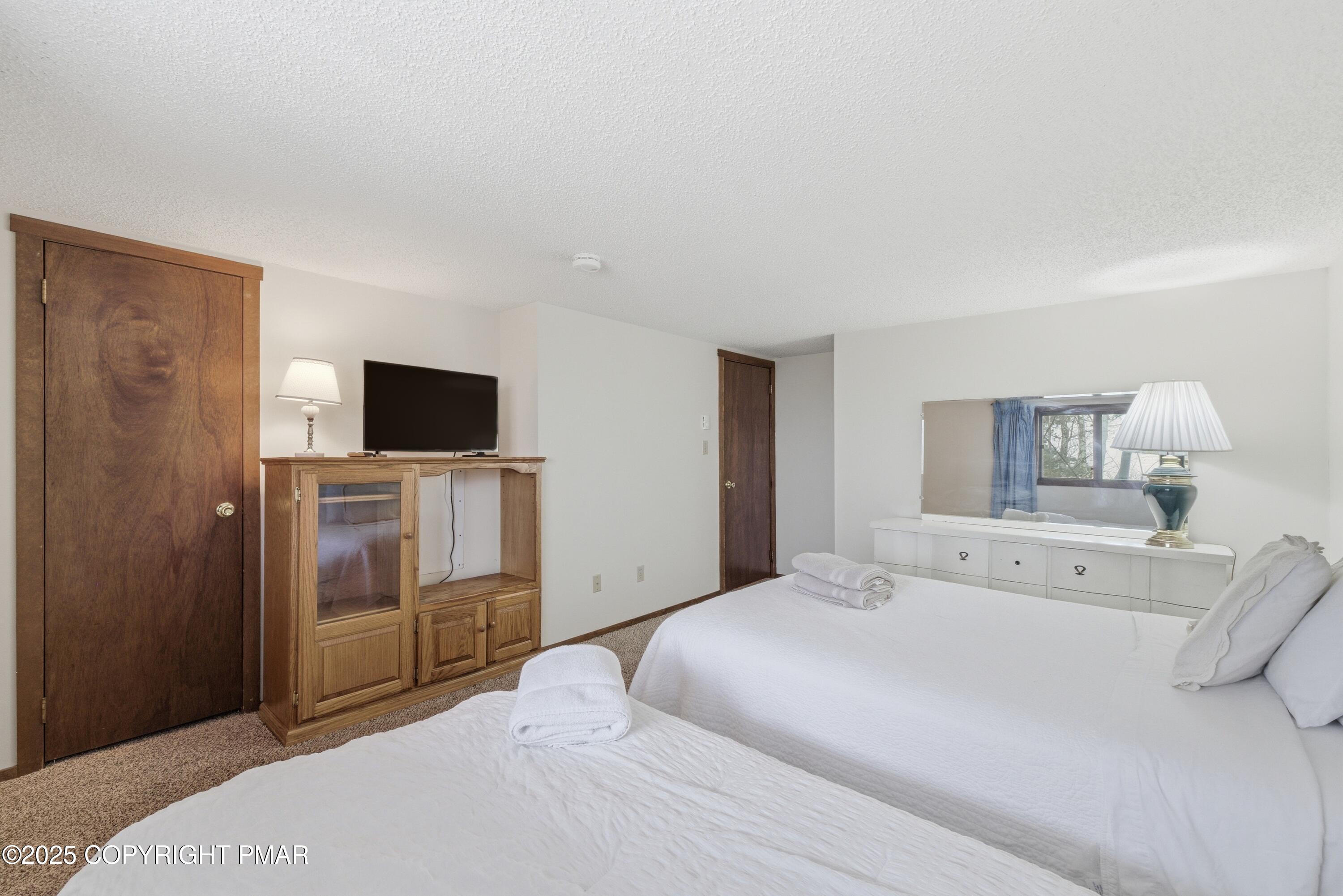 182 Upper Village Way Tannersville, PA 18372 - Photo 27 of 67 a bedroom with a bed and a flat screen tv