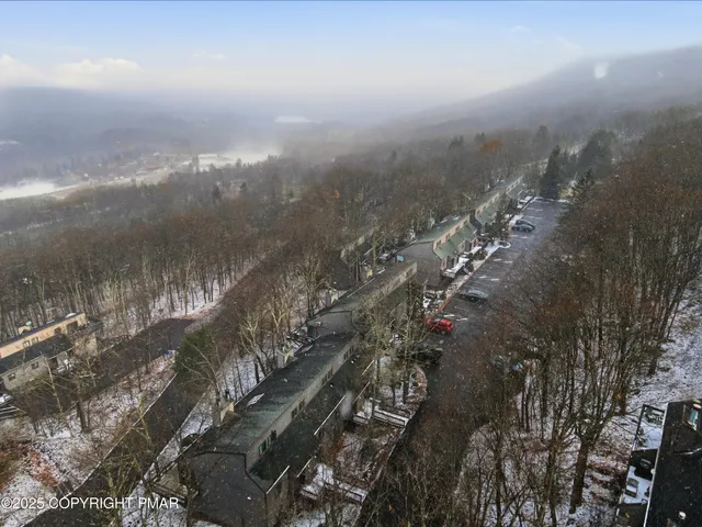 an aerial view of residential houses with outdoor space and swimming pool
