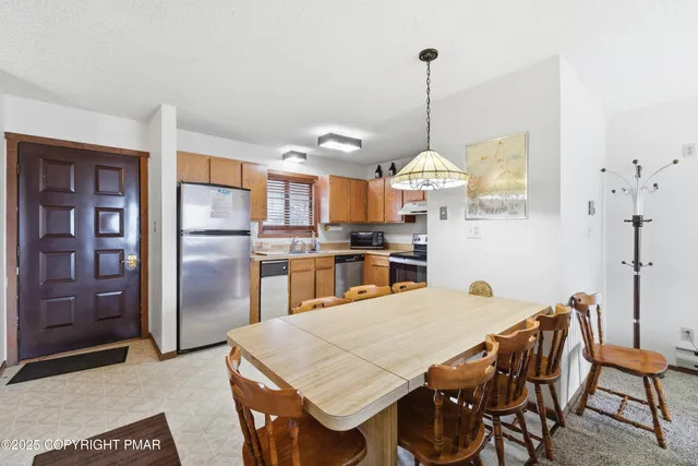a kitchen with a stove sink and refrigerator