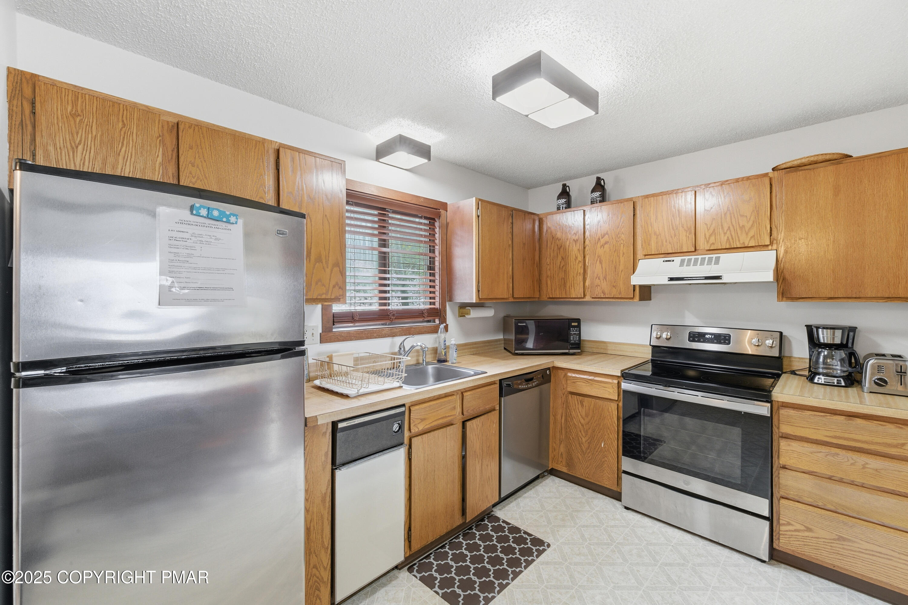 182 Upper Village Way Tannersville, PA 18372 - Photo 10 of 67 a kitchen with a sink stove and cabinets