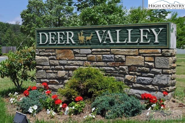143 Sports Club Lane, Unit 221 Boone, NC 28607 - Photo 12 of 14 a front view of a house with a flower garden