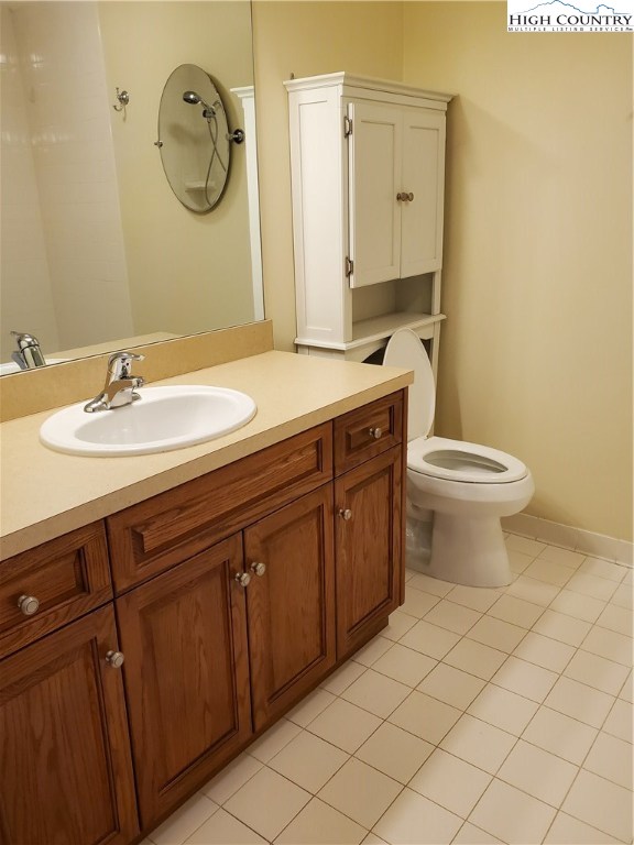 143 Sports Club Lane, Unit 221 Boone, NC 28607 - Photo 8 of 14 a bathroom with a granite countertop toilet sink and mirror