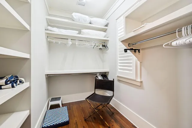a view of walk in closet with empty racks