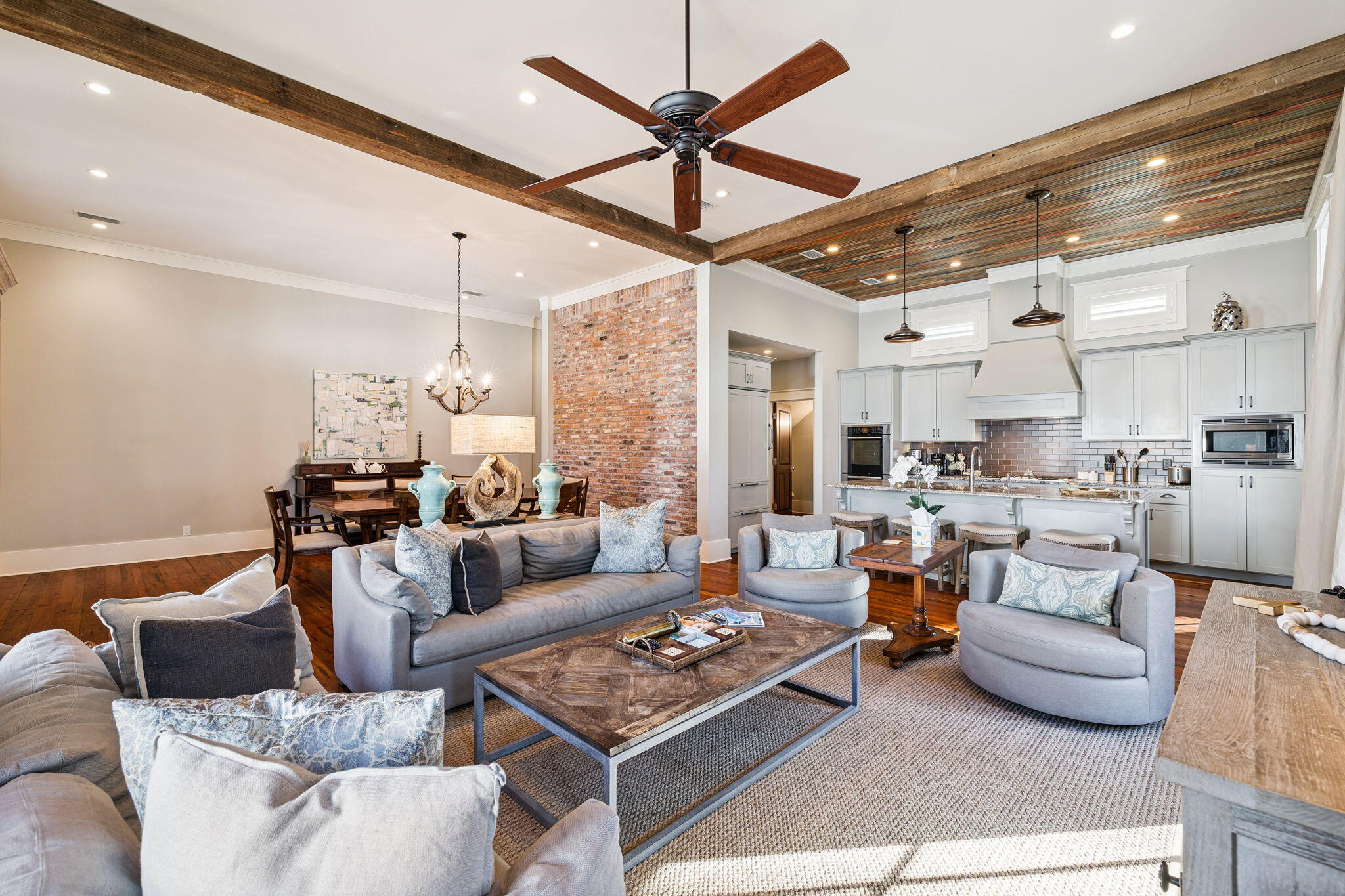 69 Bennett Santa Rosa Beach, FL 32459 - Photo 37 of 58 a living room with furniture a rug kitchen view and a chandelier